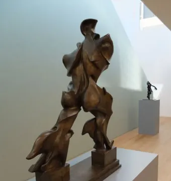 Unique Forms of Continuity in Space bronze sculpture of a striding human figure
