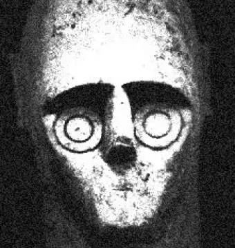 Stone head from the Giants of Mont\'e Prama with large circular eyes and thick arched brows.