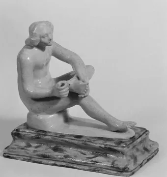 Boy with Thorn statue of a nude youth seated and looking down at his raised foot