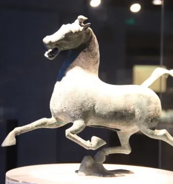 Flying Horse of Gansu bronze sculpture balancing on one hind leg with a bird-like base