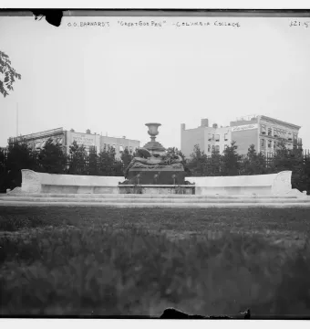 The Great God Pan fountain with a dark bronze figure at the center of a curved stone basin.