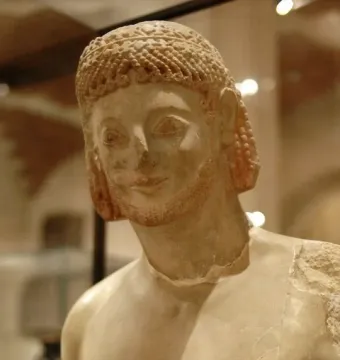 Rampin Rider sculpture showing the head and upper torso of a weathered ancient male figure with curly hair and a short beard.