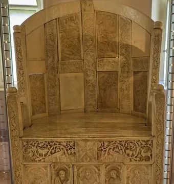 Throne of Maximian, an ornate ivory throne with carved panels of robed figures and decorative animal motifs.