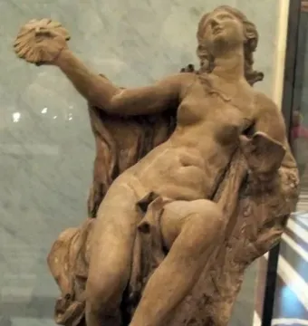 Truth Unveiled by Time sculpture showing a reclining nude female figure holding a disc aloft, with a rough unfinished figure behind her.