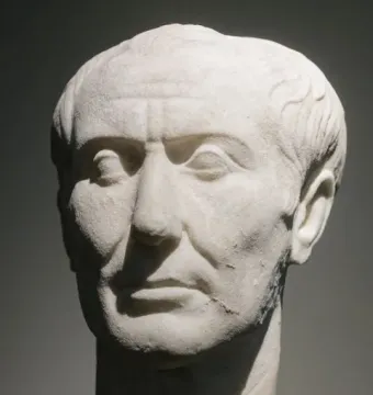 Weathered marble bust of the Tusculum portrait showing a stern-faced man with receding wavy hair and deep facial wrinkles.