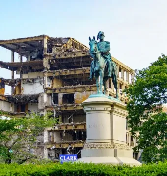 Winfield Scott equestrian statue in front of a partially demolished building.