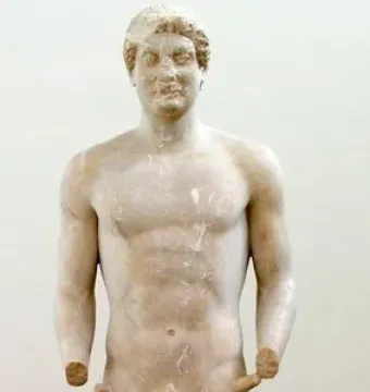 Aristodikos Kouros, a standing nude marble male statue with curly hair, broken arms, and a rectangular base.