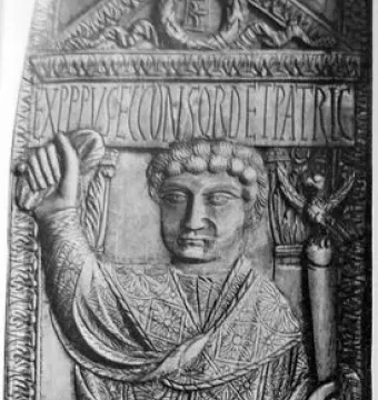 Carved consular diptych of Boethius showing a seated man in a patterned robe holding a staff, with a Latin inscription above and objects at his feet.