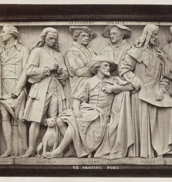 Section of the Frieze of Parnassus on the Albert Memorial showing several sculpted painters and a small dog.