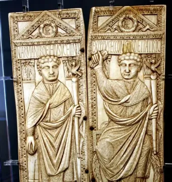 Diptych of Boethius ivory panels showing two robed male figures in high relief with decorative borders and inscriptions.