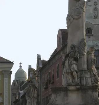 Lower and middle sections of the Holy Trinity Monument with sculpted figures and ornate Baroque decoration.