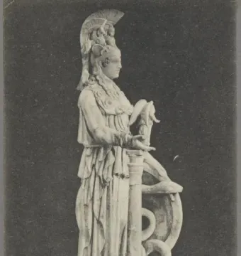 Varvakeion Athena shown in profile, holding a small winged figure beside a shield and column.