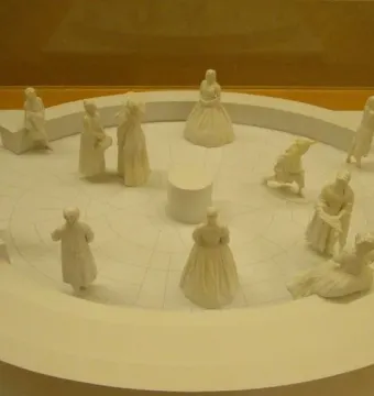 Virginia Women\'s Monument model showing miniature female figures arranged around a circular platform with a central column.