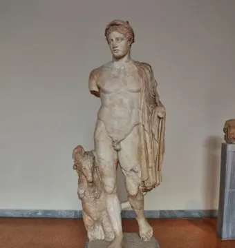Hermes Criophorus marble statue of a nude male figure standing beside a ram, with both arms missing.