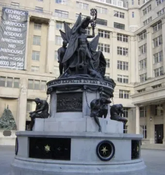 Nelson\'s Monument at Exchange Flags, showing a bronze figure group on a stone base with chained figures around the lower level.