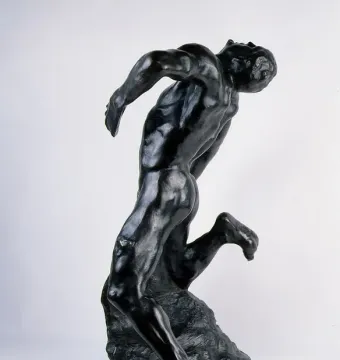 The Falling Man bronze sculpture shown against a white background in a forward-leaning pose.