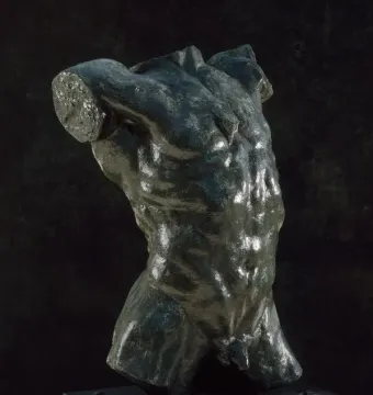 The Falling Man bronze torso mounted on a light-colored base against a dark background.