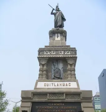 Cuauhtémoc Monument with a bronze figure atop a carved stone base flanked by seated jaguar statues.