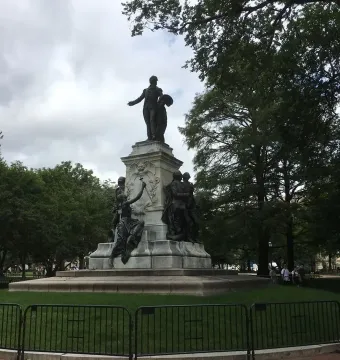 The Marquis de Lafayette statue, a large bronze monument with figures on a stone pedestal in a fenced park.