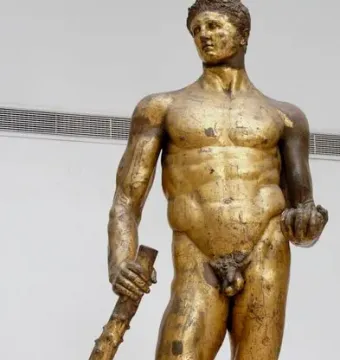Hercules of the Forum Boarium statue holding a club and three golden apples.