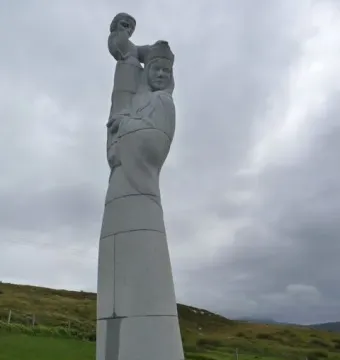 Our Lady of the Isles statue with a crowned woman holding a child on a stone base