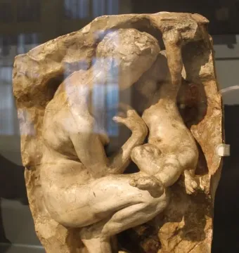 Young Mother in the Grotto relief showing a crouching adult embracing a child.