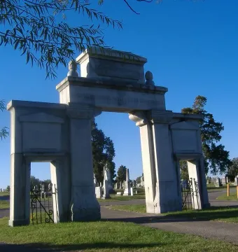 Confederate Memorial Gateway stone entrance with vehicle and pedestrian arches in a cemetery