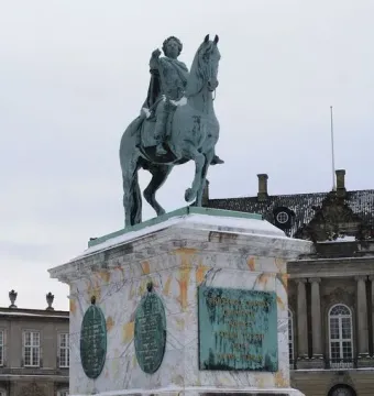 Frederick V equestrian statue on a marble pedestal with chain fencing in a snowy square