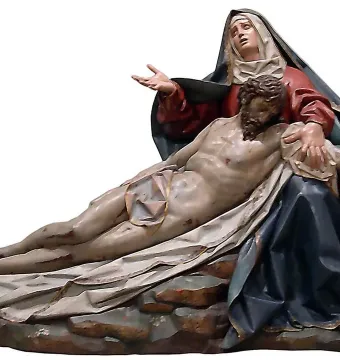 Pietà sculpture in polychrome wood showing the Virgin Mary supporting the lifeless body of Christ.