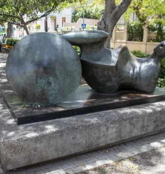 The Goslar Warrior bronze sculpture with an abstract reclining form and spherical element on a stone plinth.