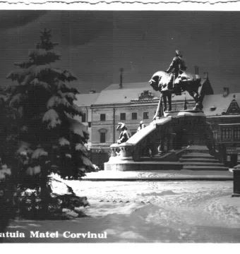 Matthias Corvinus Monument showing an equestrian statue with smaller figures at the base in a snowy setting.
