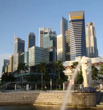 The Merlion statue spouting water with Singapore’s skyline behind it.