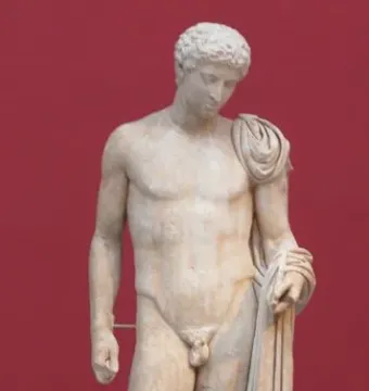 Hermes of Aegium marble statue, shown full length with a draped cloth over his left shoulder and arm beside a support on a red background.