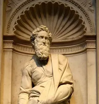 Marble statue of Saint Paul standing in an ornate niche with flowing robes and a bearded face.