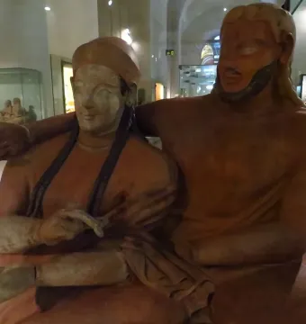 Sarcophagus of the Spouses showing a terracotta reclining couple, with the woman pointing outward and the bearded man resting an arm around her shoulder.