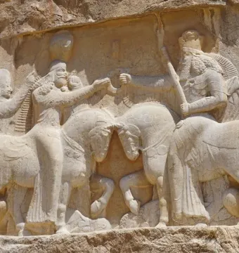 Ardashir Investiture Relief showing two mounted figures facing each other with smaller figures behind them and forms beneath the horses.