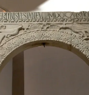 Archway from the Baptistry of Callistus with peacocks, a Latin inscription, and carved floral and geometric decoration.