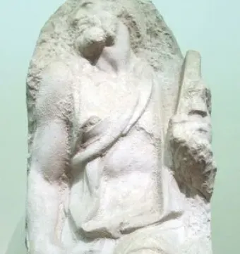 Saint Matthew, an unfinished marble sculpture of a bearded male figure emerging from rough stone.