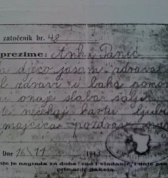 A close-up of an aged handwritten letter with printed lines and a circular 1943 stamp.