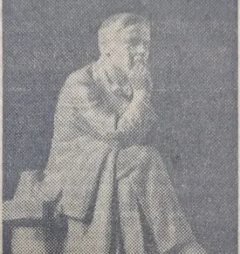 Chekhov Monument showing a bearded man seated on a bench, resting his chin on his hand.