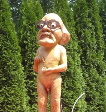 Citizen Włapko sculpture of a nude figure with an oversized head, glasses, and a bomb at its feet.