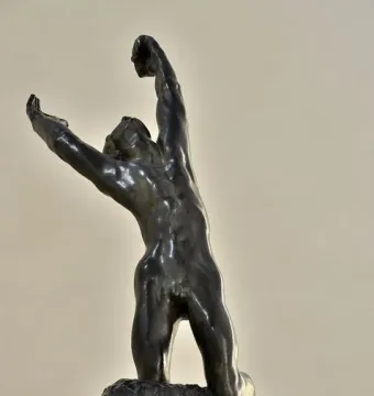The Prodigal Son by Auguste Rodin, a bronze sculpture of a kneeling nude man with arms raised and head thrown back.