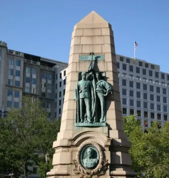 Stephenson Memorial granite monument with bronze figures of a soldier and sailor, a bust, and a flag