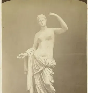 Townley Venus, a classical female statue standing on a pedestal with one arm raised and the other extended forward.