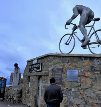 Géant du Tourmalet sculpture of a nude male cyclist climbing on a bicycle, with the Col du Tourmalet sign below.