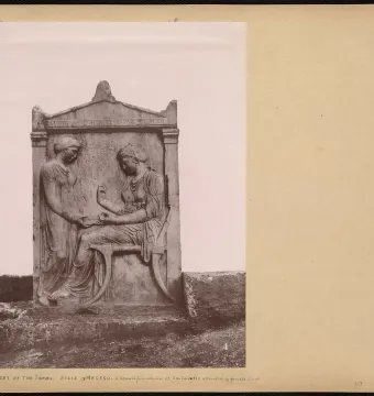Grave Stele of Hegeso showing two draped women, one seated and examining a small object while another stands beside her.