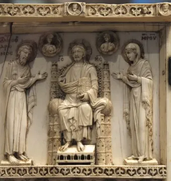 Harbaville Triptych ivory carving with a central seated figure flanked by haloed figures and hinged side panels with standing attendants.