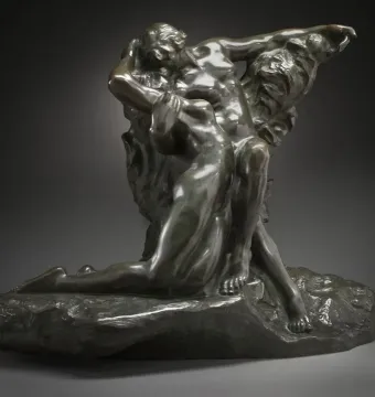 The Eternal Springtime bronze sculpture of a nude man embracing a kneeling nude woman on a rocky base.
