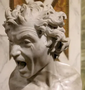 Damned Soul, a white marble bust with a contorted screaming face and curly hair.