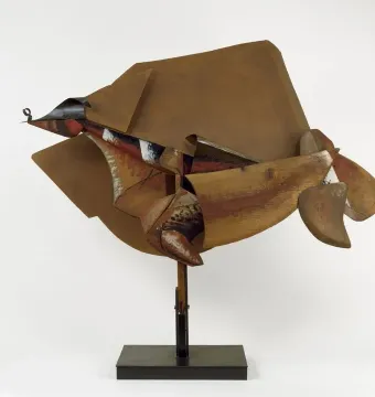 Dynamism of a Speeding Horse + Houses sculpture with layered brown, red, and black geometric forms on a black base.